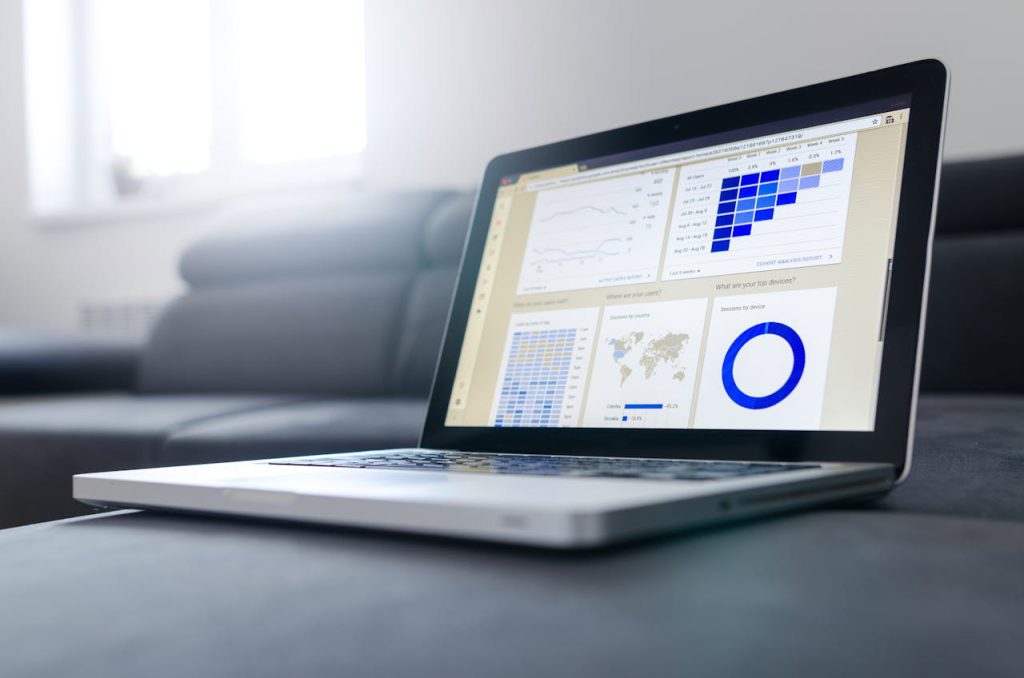 Overcoming Challenges Lessons Every Entrepreneur Must Learn Sleek laptop showcasing data analytics and graphs on the screen in a bright room.