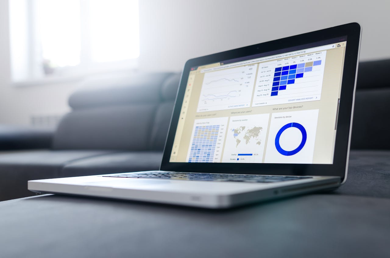who-we-are-img Sleek laptop showcasing data analytics and graphs on the screen in a bright room.